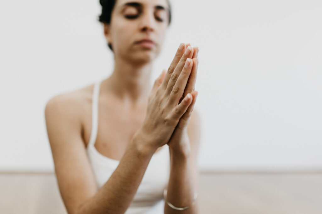 Woman meditating in prayer pose